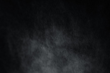 Water spray splash overlay effect on black background. Look like raining with wind and fog