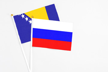Russia and Bosnia Herzegovina stick flags on white background. High quality fabric, miniature...