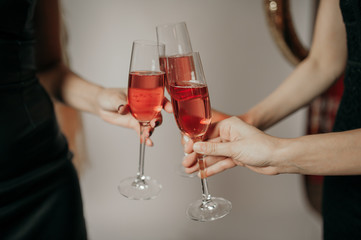  three glasses of champagne in hands on a light background