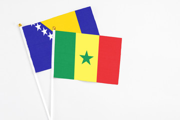 Senegal and Bosnia Herzegovina stick flags on white background. High quality fabric, miniature...
