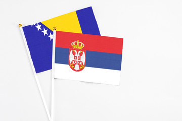 Serbia and Bosnia Herzegovina stick flags on white background. High quality fabric, miniature...
