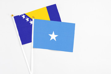 Somalia and Bosnia Herzegovina stick flags on white background. High quality fabric, miniature...