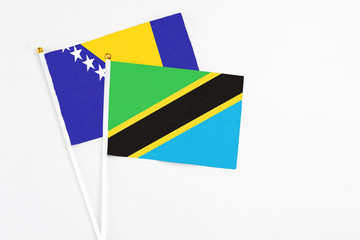Tanzania and Bosnia Herzegovina stick flags on white background. High quality fabric, miniature...