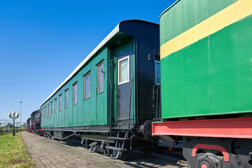 Obraz premium An old passenger railway car stands on rails