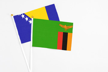 Zambia and Bosnia Herzegovina stick flags on white background. High quality fabric, miniature...