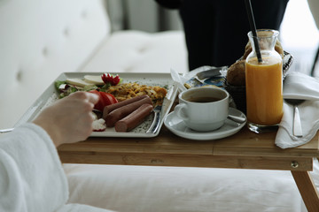 Breakfast in bed, cozy hotel room. 