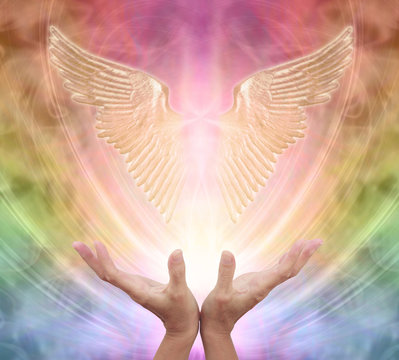 Seeking help and guidance from your Guardian Angel - female hands reaching up towards a pair of gleaming shimmering angel wings against an ethereal rainbow coloured energy background