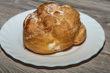 Fresh eclair with whipped cream.