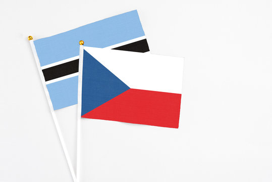 Czech Republic and Botswana stick flags on white background. High quality fabric, miniature national flag. Peaceful global concept.White floor for copy space.