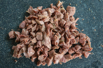 Pieces of boiled lamb meat on a small plate.
