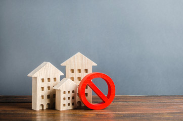Apartment buildings and red prohibition symbol NO. Unavailable and expensive housing. Lack of...