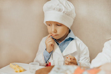 little boy enthusiastically plays doctor