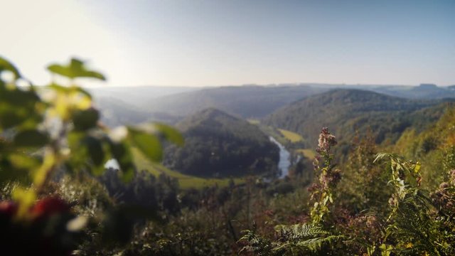Ardennes Belgium with meandering horsshoe river. Camera focus pull and tracking.