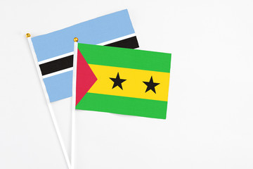 Sao Tome And Principe and Botswana stick flags on white background. High quality fabric, miniature national flag. Peaceful global concept.White floor for copy space.