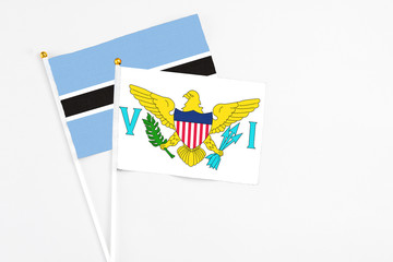 United States Virgin Islands and Botswana stick flags on white background. High quality fabric, miniature national flag. Peaceful global concept.White floor for copy space.