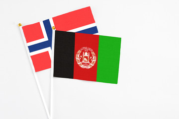 Afghanistan and Bouvet Islands stick flags on white background. High quality fabric, miniature national flag. Peaceful global concept.White floor for copy space.