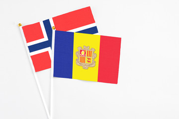 Andorra and Bouvet Islands stick flags on white background. High quality fabric, miniature national flag. Peaceful global concept.White floor for copy space.
