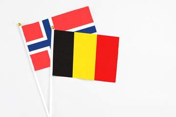 Belgium and Bouvet Islands stick flags on white background. High quality fabric, miniature national flag. Peaceful global concept.White floor for copy space.