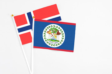 Belize and Bouvet Islands stick flags on white background. High quality fabric, miniature national flag. Peaceful global concept.White floor for copy space.