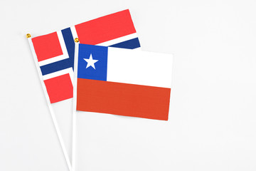 Chile and Bouvet Islands stick flags on white background. High quality fabric, miniature national flag. Peaceful global concept.White floor for copy space.