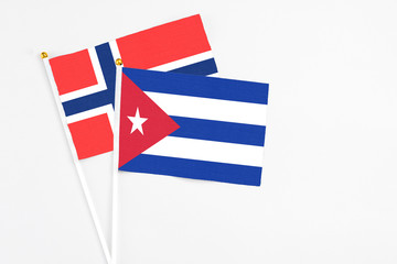Cuba and Bouvet Islands stick flags on white background. High quality fabric, miniature national flag. Peaceful global concept.White floor for copy space.