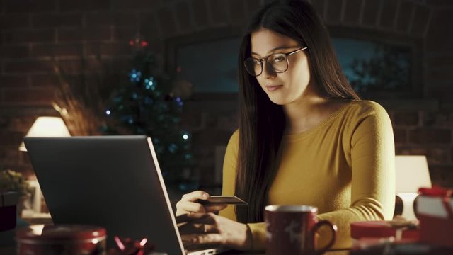Happy woman doing online shopping for Christmas