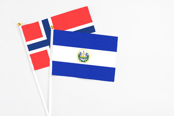 El Salvador and Bouvet Islands stick flags on white background. High quality fabric, miniature national flag. Peaceful global concept.White floor for copy space.