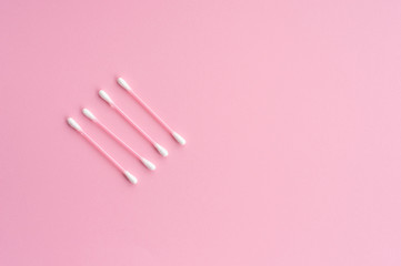 cotton swabs on pink background