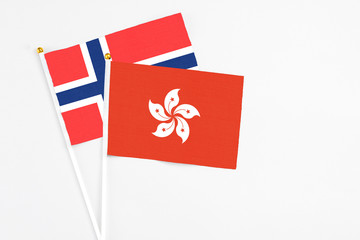 Hong Kong and Bouvet Islands stick flags on white background. High quality fabric, miniature national flag. Peaceful global concept.White floor for copy space.