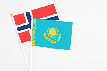 Kazakhstan and Bouvet Islands stick flags on white background. High quality fabric, miniature national flag. Peaceful global concept.White floor for copy space.