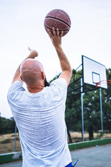 Young basketball player shooting a triple