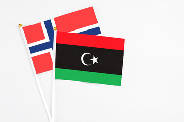 Libya and Bouvet Islands stick flags on white background. High quality fabric, miniature national flag. Peaceful global concept.White floor for copy space.