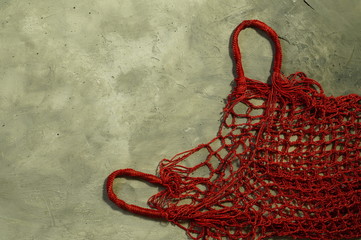 Red, empty, wicker bag-string bag for carrying various items. Reusable, the concept of zero waste....