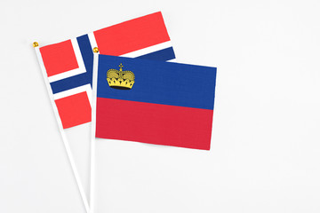 Liechtenstein and Bouvet Islands stick flags on white background. High quality fabric, miniature national flag. Peaceful global concept.White floor for copy space.