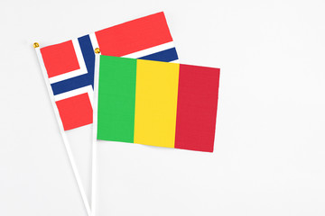 Mali and Bouvet Islands stick flags on white background. High quality fabric, miniature national flag. Peaceful global concept.White floor for copy space.