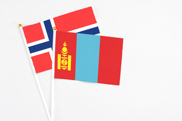 Mongolia and Bouvet Islands stick flags on white background. High quality fabric, miniature national flag. Peaceful global concept.White floor for copy space.