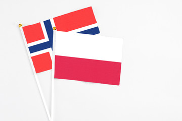 Poland and Bouvet Islands stick flags on white background. High quality fabric, miniature national flag. Peaceful global concept.White floor for copy space.