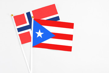 Puerto Rico and Bouvet Islands stick flags on white background. High quality fabric, miniature national flag. Peaceful global concept.White floor for copy space.