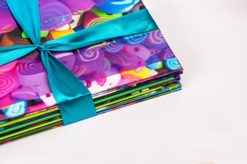 Colored books in a stack. Children's books in a gift ribbon. Bright colorful little books for children.