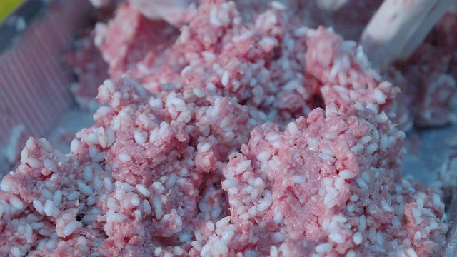female hands mix minced meat