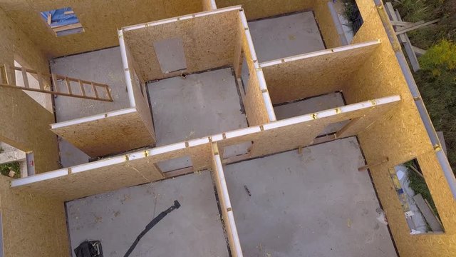 Construction of new and modern modular house. Walls made from composite wooden sip panels with styrofoam insulation inside. Building new frame of energy efficient home concept.