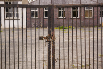 Set of locked security gates at a derelict or abandoned industrial or commercial premises