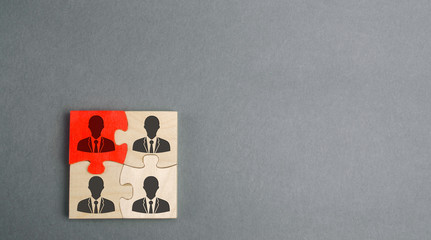 Wooden puzzles with the image of workers. The concept of personnel management in the company. Dismissing an employees from a team. Demotion. Bad worker. Staff cuts. Human resources.