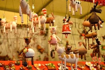 Florence, ITALY - DECEMBER 2018: small decorated bells hanging from the roof at the Christmas market in front of the 'Basilica of Santa Croce'. Christmas