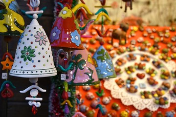 Florence, ITALY - DECEMBER 2018: small decorated bells hanging from the roof at the Christmas market in front of the 'Basilica of Santa Croce'. Christmas