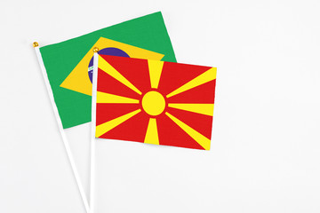 Macedonia and Brazil stick flags on white background. High quality fabric, miniature national flag. Peaceful global concept.White floor for copy space.