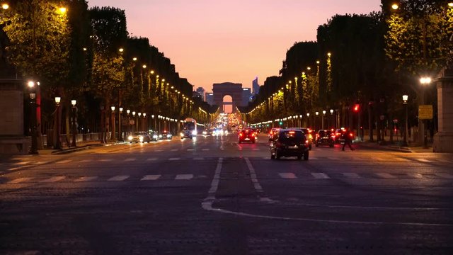 The Arc de Triomphe in Paris during twilight sky