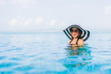 Portrait beautiful young asian women happy smile relax outdoor swimming pool in resort