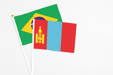Mongolia and Brazil stick flags on white background. High quality fabric, miniature national flag. Peaceful global concept.White floor for copy space.