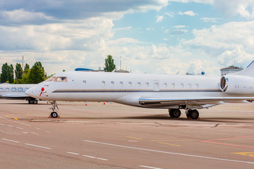 Fototapeta na wymiar Private jet on the runway. Jet airplane stop for wait VIP passenger on runway.